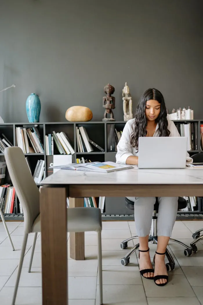Businesswoman focused on her work at a modern office desk. Clean and efficient workspace.